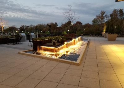 Illuminated fountain at dusk.