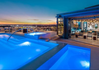 Illuminated 569 square foot two level swimming pool, with an elevated 30 square foot water feature and vanishing edge.